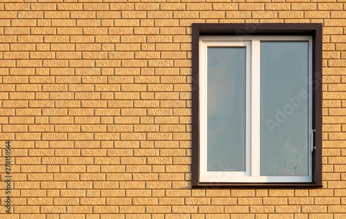 A window in a house with brick walls