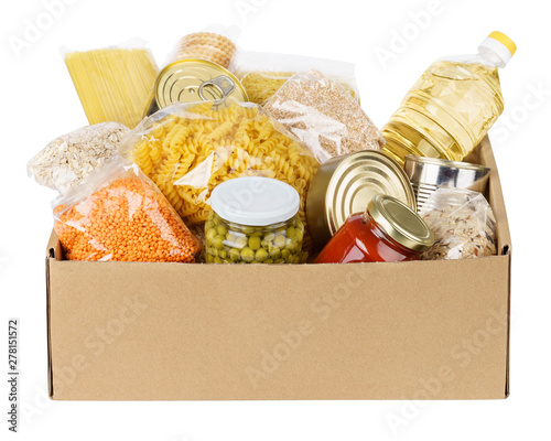 Fotografia Various canned food, pasta and cereals in a cardboard box.