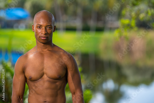 Photo of a fitness model shallow depth of focus. Image lit by off camera flash