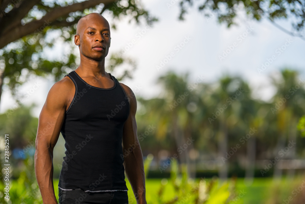 Shallow focus photo of a young black fitness model posing outdoors in the park Shallow focus photo of a young black fitness model posing outdoors in the park