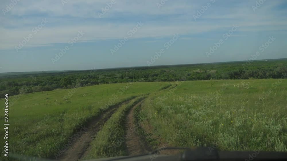 the car is driving along a country road nature .man driving a car on nature view from the window hills lifestyle summer greens. car journey trip concept the car is driving along a country road nature .man driving a car on nature view from the window hills lifestyle summer greens. car journey trip concept