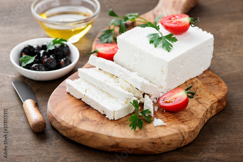 Sliced Feta cheese with herbs and olive oil. photo