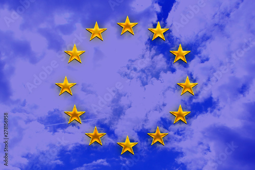 stylized european union flag, symbol of united europe on a translucent blue sky background