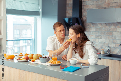 Loving caring husband giving some peach for his woman