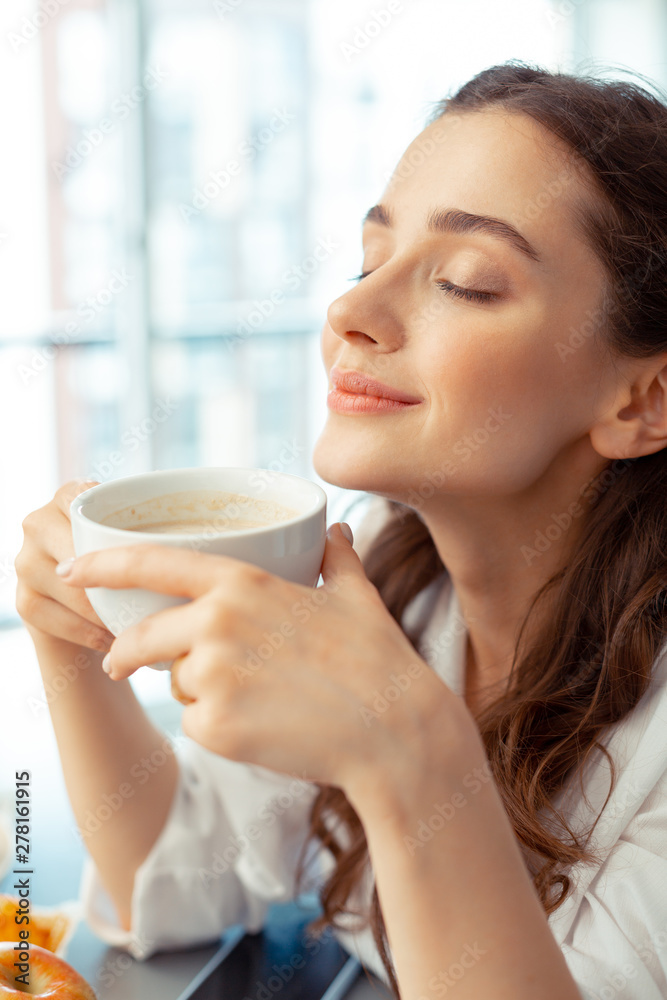 Woman enjoying the smell of freshly brewed coffee Woman enjoying the smell of freshly brewed coffee