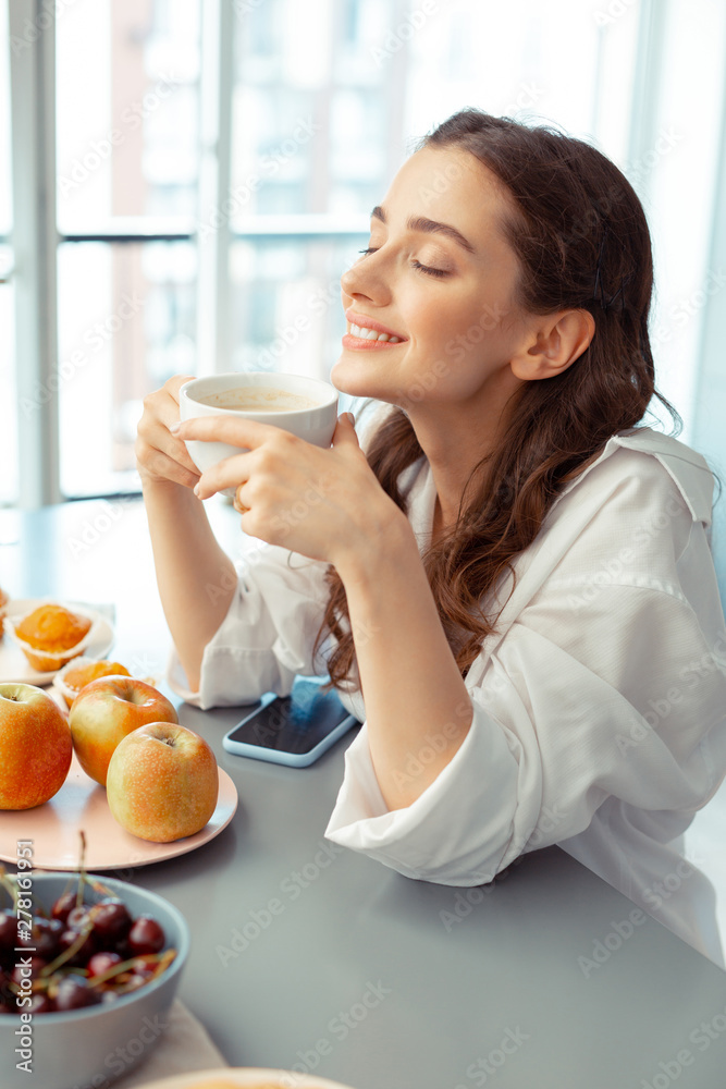 Woman thinking about the day drinking coffee in the morning Woman thinking about the day drinking coffee in the morning