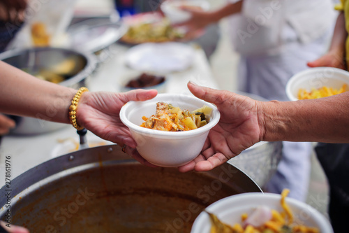 Hands of beggars accepting food from the hands of volunteers who come to help free food breaks : Social Problems of Poverty Helped by Feeding