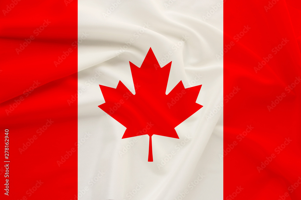 Canada national flag on gentle silk with wind folds, travel concept, immigration, politics Canada national flag on gentle silk with wind folds, travel concept, immigration, politics