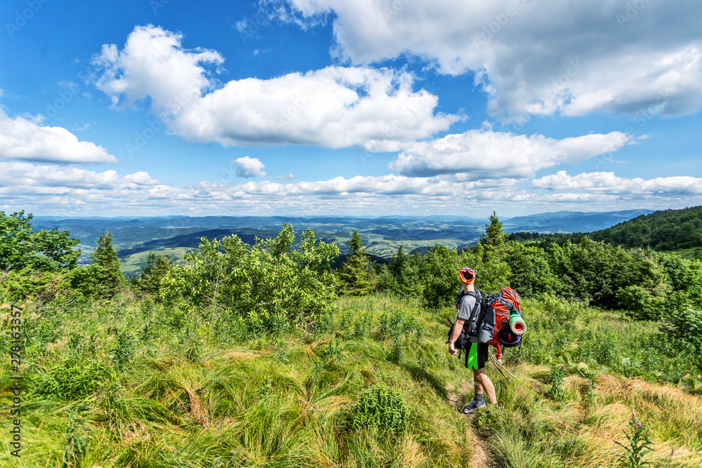 Traveler with a backpack. Mountain landscape with beautiful clouds. Ukraine. Carpathians. Travels. Hiking.