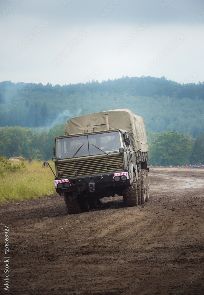 Cargo military vehicle carrying supplies. On the battlefield.