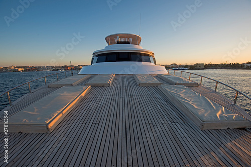 View over the bow over a large luxury motor yacht