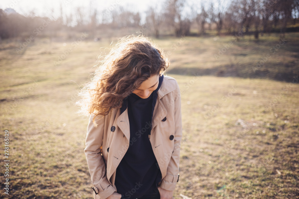 Smiling young woman dressed in beige coat Smiling young woman dressed in beige coat