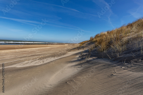 Domburg - View to Grass Dunes with only a few people on the Beach / Netherlands