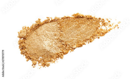 Texture of gold eye shadow isolated on white background. Macro texture of broken gold powder photo