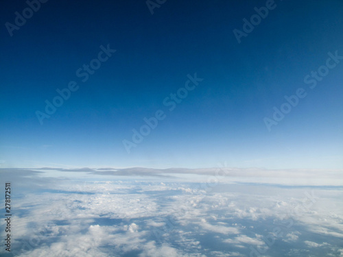 Clear blue sky with calming bed of white clouds from a flight in Spring or Summer © Khairil Zhafri