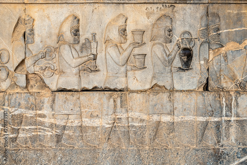 Ancien inscriptions on the walls of Persepolis, the ancient capital of old Persian Achaemenid Empire in Iran, Zoroastrian symbol Faravahar photo