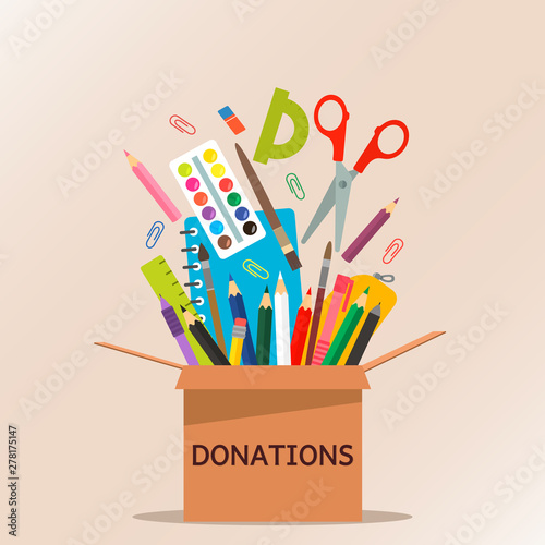 brown cardboard box for donations full of stationery to a school for poor people.