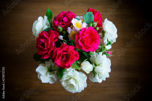 bouquet of beautiful red and white roses on a wooden © Peredniankina