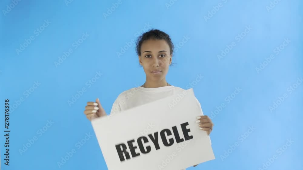 Afro-American Girl Activist With Recycle Poster showing thumb up on blue background Afro-American Girl Activist With Recycle Poster showing thumb up on blue background