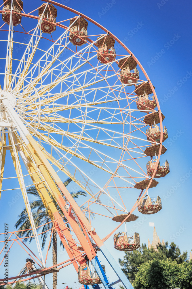 Ferris wheel in an amusement park at summer