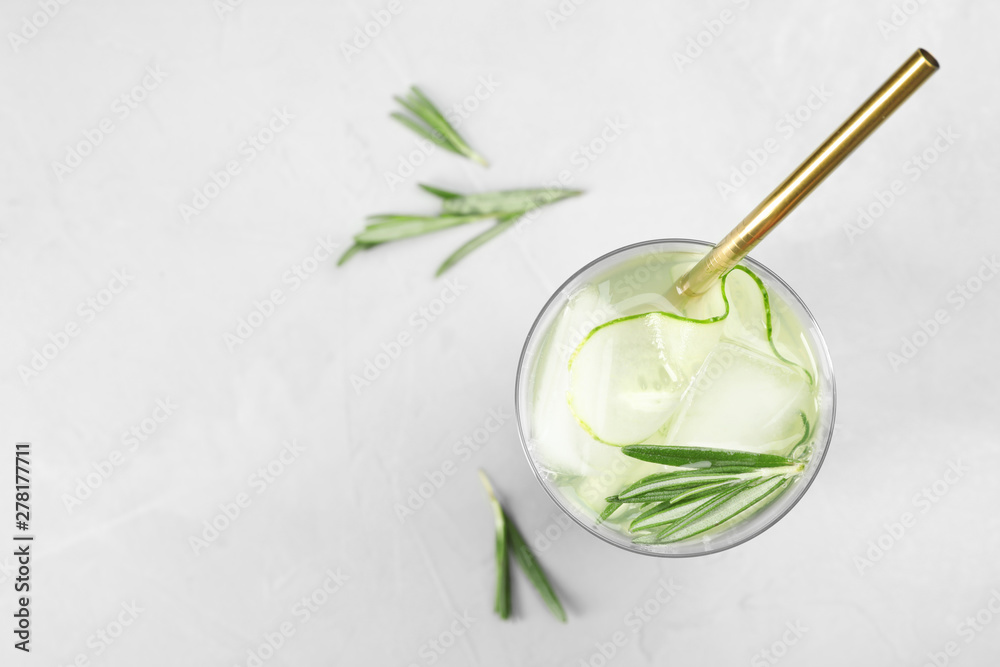 Glass of refreshing cucumber lemonade on table, top view with space for text. Summer drink Glass of refreshing cucumber lemonade on table, top view with space for text. Summer drink
