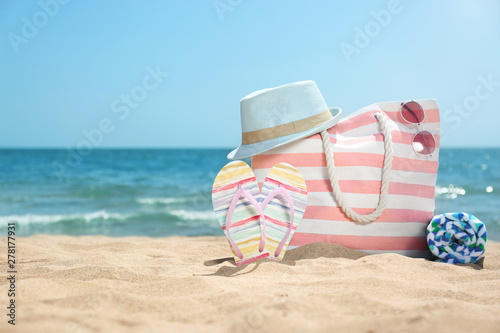 Set of different beach objects on sand near sea. Space for text