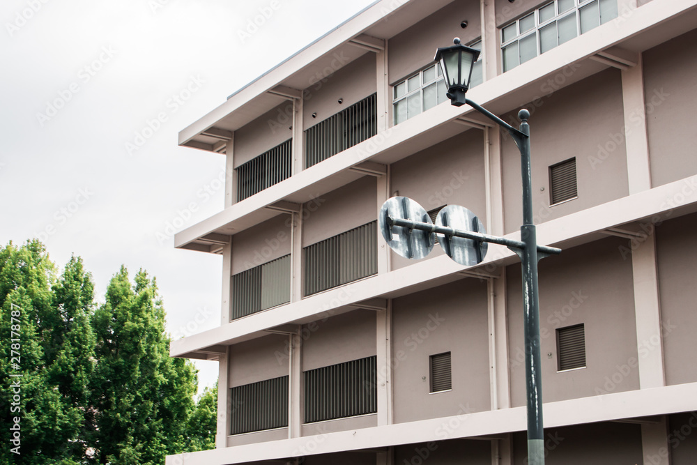 The image of grey apartment and woods in cloudy sky, Hiroshima, Japan.