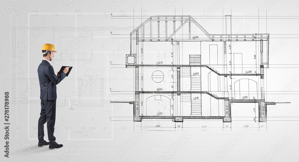 Architect watching a 2 dimension house plan Architect watching a 2 dimension house plan
