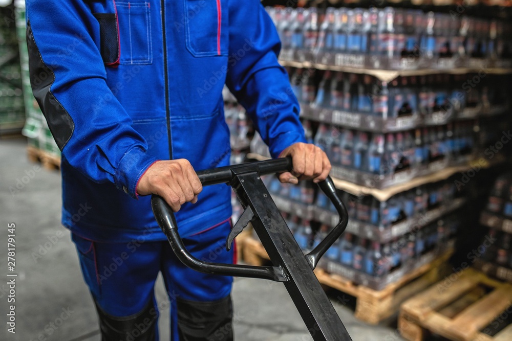 men's hands hold a shipping cart in warehouse