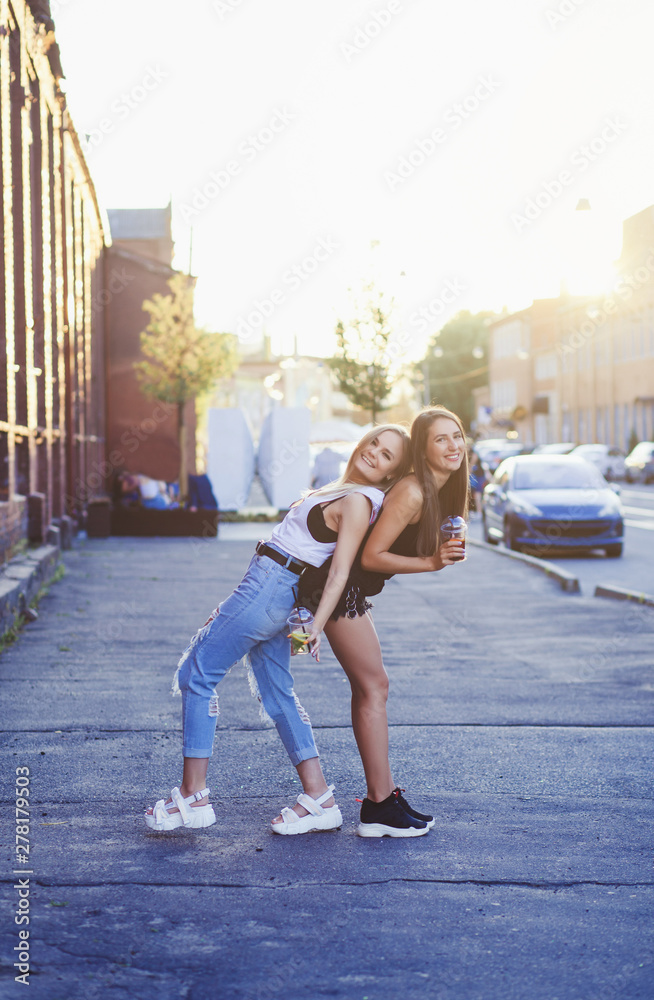 Fashion summer image of two girls having fun in street