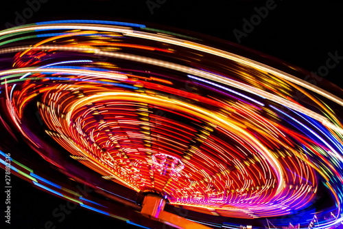 an illuminated carousel at the fun fair at night