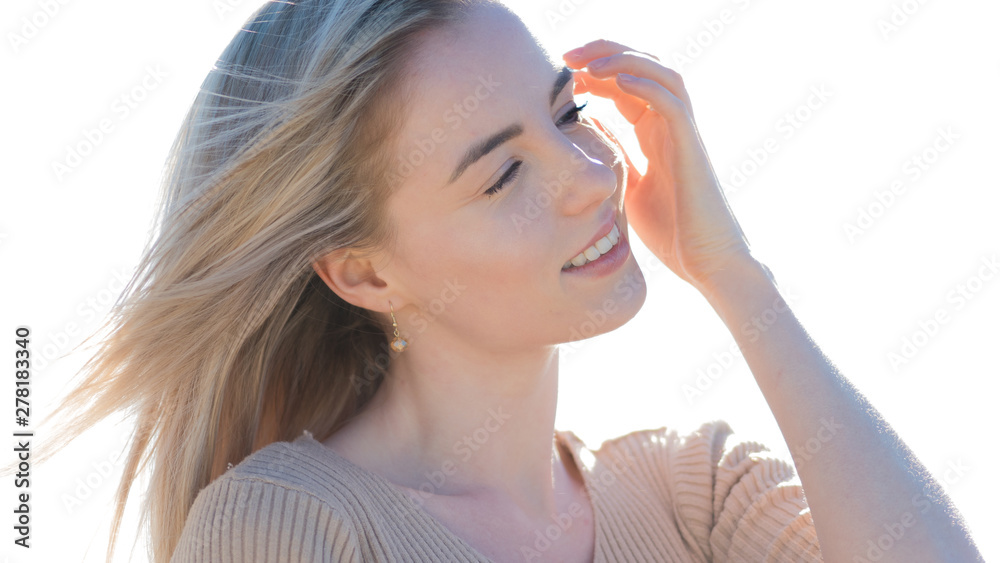 Young cheerful girl on the seashore. Young blonde woman smiling. Trendy beige skirt Young cheerful girl on the seashore. Young blonde woman smiling. Trendy beige skirt