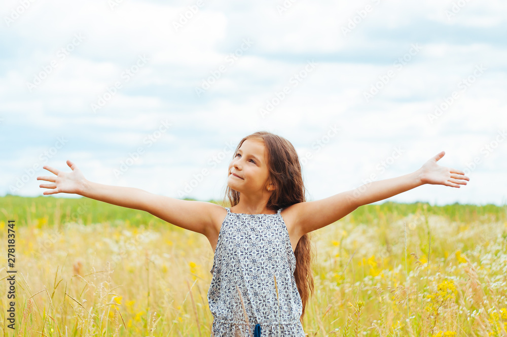 Emotional portrait of a little girl in the field enjoying the summer Emotional portrait of a little girl in the field enjoying the summer