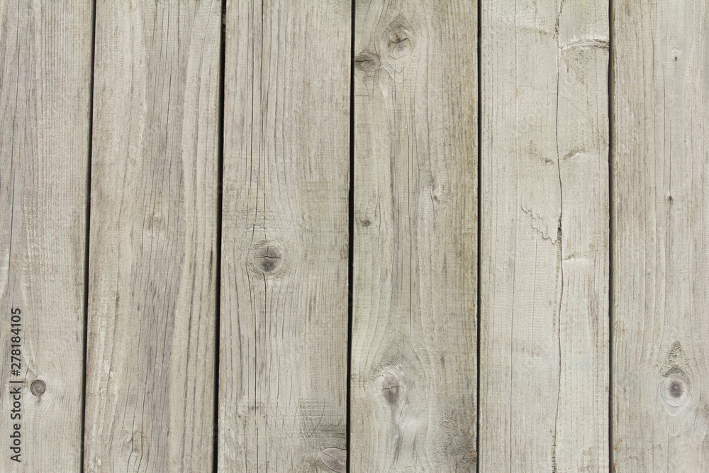 Wooden gray fence. From boards. not painted not treated. Background texture. Wooden gray fence. From boards. not painted not treated. Background texture.