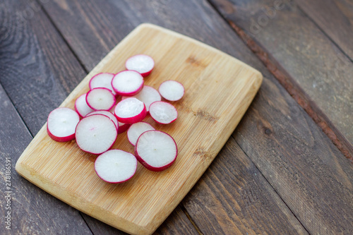 sliced pieces of fresh radish on a cutting board