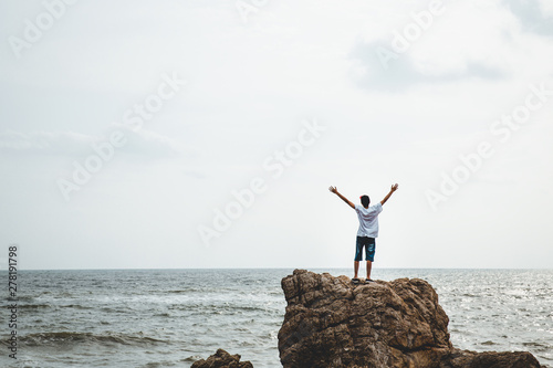 Traveler man on sea cliff