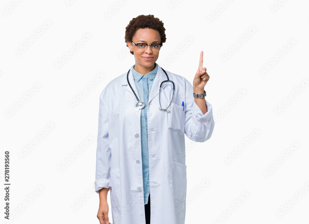 Young african american doctor woman wearing medical coat over isolated background showing and pointing up with finger number one while smiling confident and happy. Young african american doctor woman wearing medical coat over isolated background showing and pointing up with finger number one while smiling confident and happy.