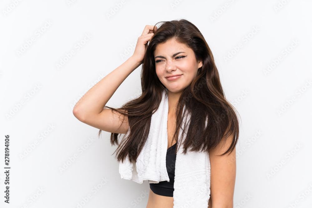 Teenager sport girl over isolated white background having doubts and with confuse face expression Teenager sport girl over isolated white background having doubts and with confuse face expression