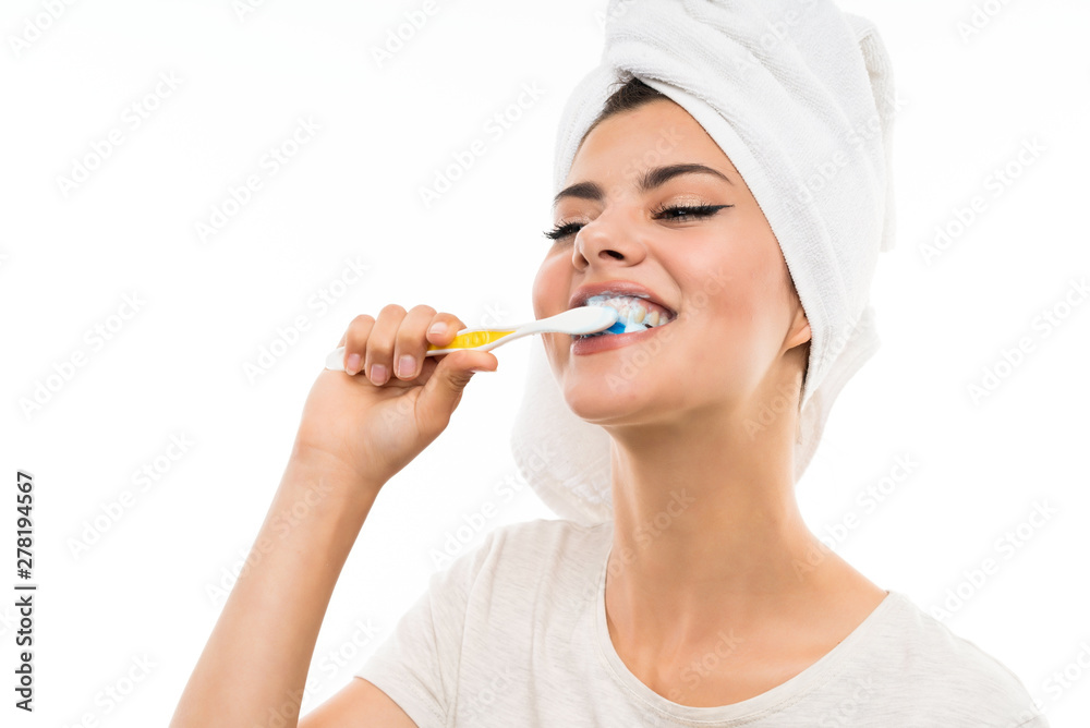 Teenager girl over isolated white background brushing her teeths Teenager girl over isolated white background brushing her teeths