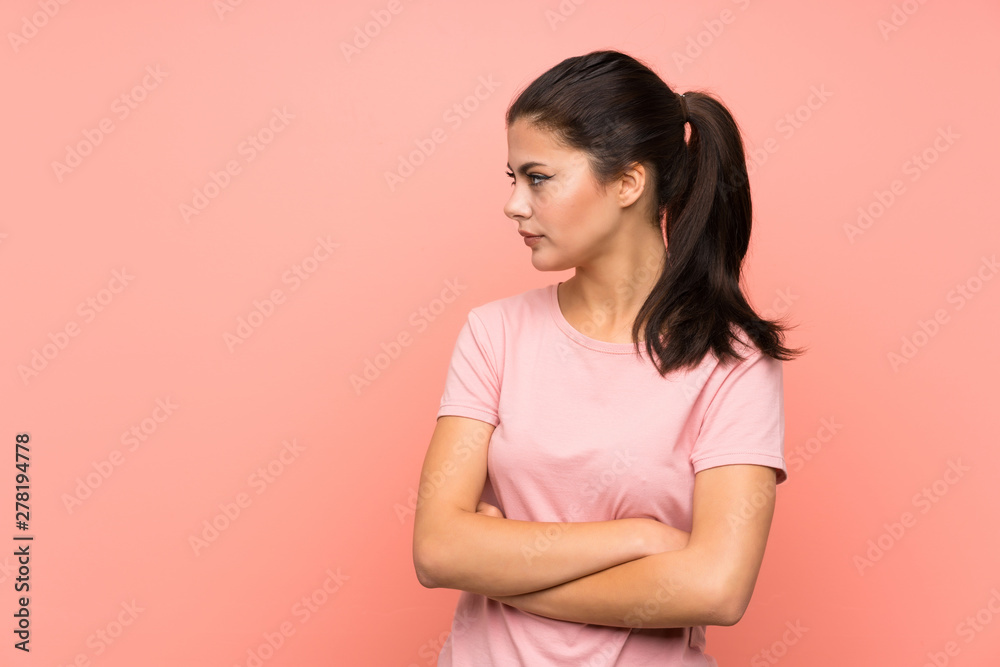 Teenager girl over isolated pink background standing and looking side Teenager girl over isolated pink background standing and looking side