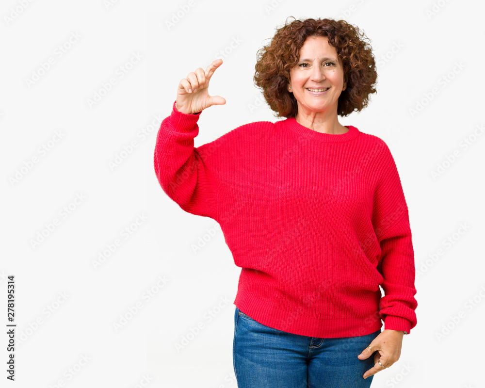Beautiful middle ager senior woman red winter sweater over isolated background smiling and confident gesturing with hand doing size sign with fingers while looking and the camera. Measure concept. Beautiful middle ager senior woman red winter sweater over isolated background smiling and confident gesturing with hand doing size sign with fingers while looking and the camera. Measure concept.
