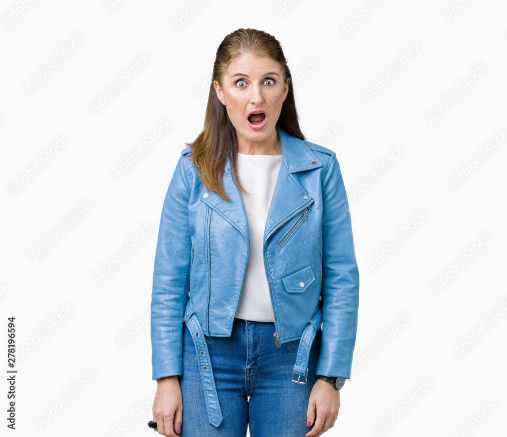 Beautiful middle age mature woman wearing fashion leather jacket over isolated background afraid and shocked with surprise expression, fear and excited face. Beautiful middle age mature woman wearing fashion leather jacket over isolated background afraid and shocked with surprise expression, fear and excited face.
