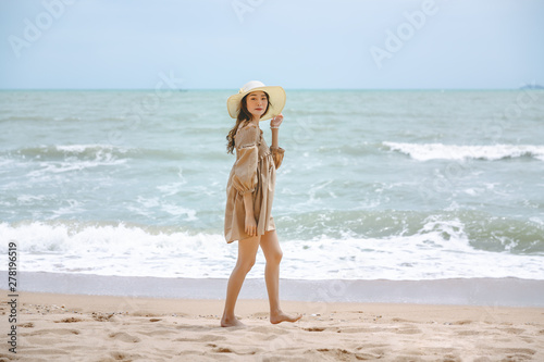 Travel woman walking on beach