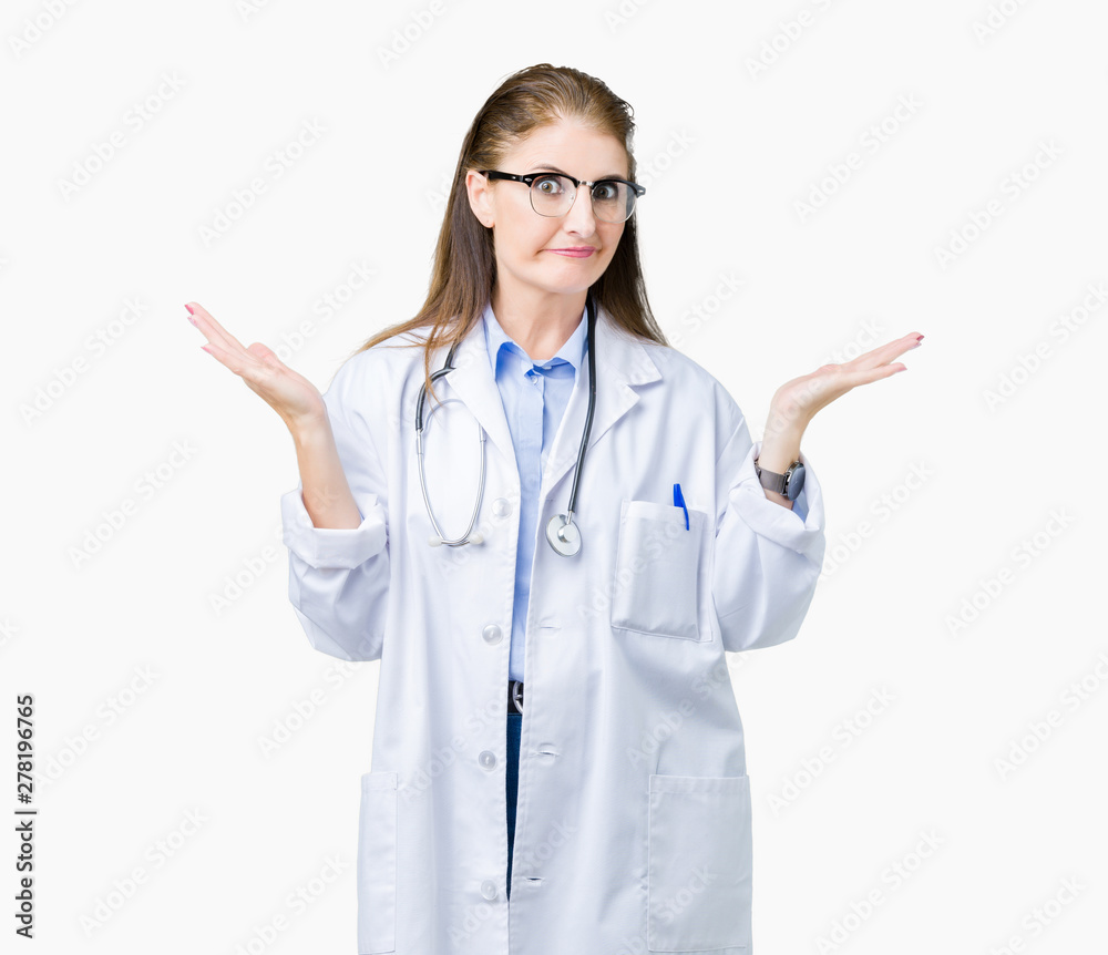 Middle age mature doctor woman wearing medical coat over isolated background clueless and confused expression with arms and hands raised. Doubt concept. Middle age mature doctor woman wearing medical coat over isolated background clueless and confused expression with arms and hands raised. Doubt concept.