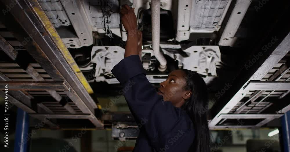 4K Pan out from close up, portrait smiling female mechanic in garage workshop. Slow motion 4K Pan out from close up, portrait smiling female mechanic in garage workshop. Slow motion