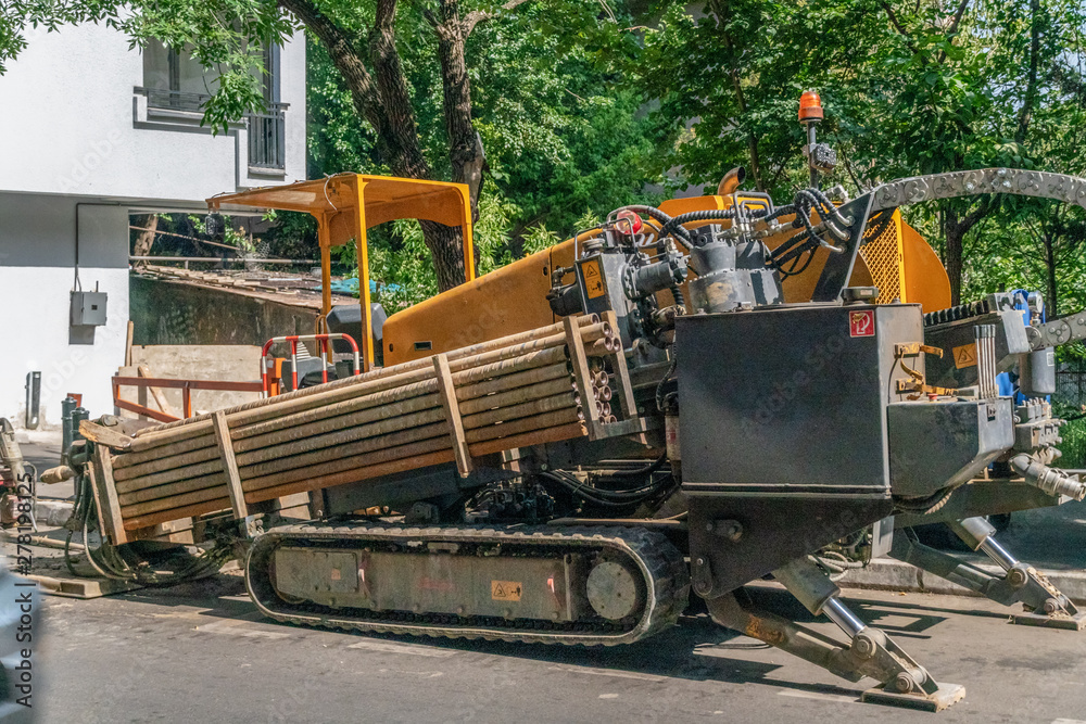 close excavator tracks on the construction site on the road, pipes. working equipment with tracks close excavator tracks on the construction site on the road, pipes. working equipment with tracks
