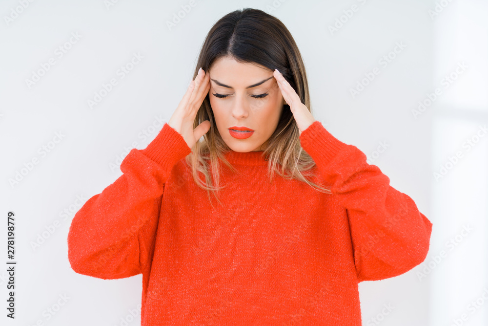 Young woman wearing casual red sweater over isolated background with hand on head for pain in head because stress. Suffering migraine. Young woman wearing casual red sweater over isolated background with hand on head for pain in head because stress. Suffering migraine.