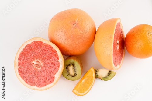 Mix of orange, kiwi, grapefruit on white background. Citrus fruit. Healthy freshness food. Orange fruit with vitamin