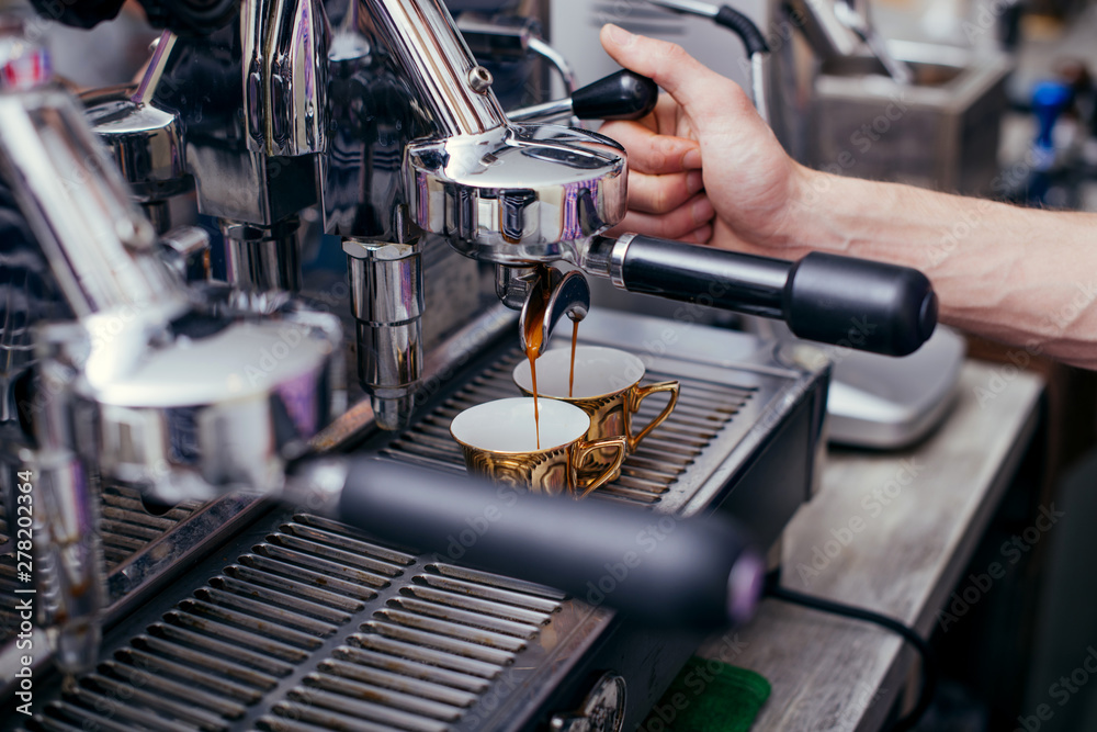 Coffee maker with coffee cup process of being made in a cafe Coffee maker with coffee cup process of being made in a cafe