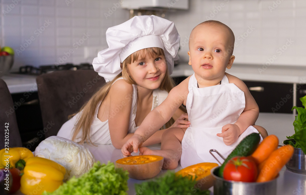 little girl and boy, white chef hat, vegetables little girl and boy, white chef hat, vegetables